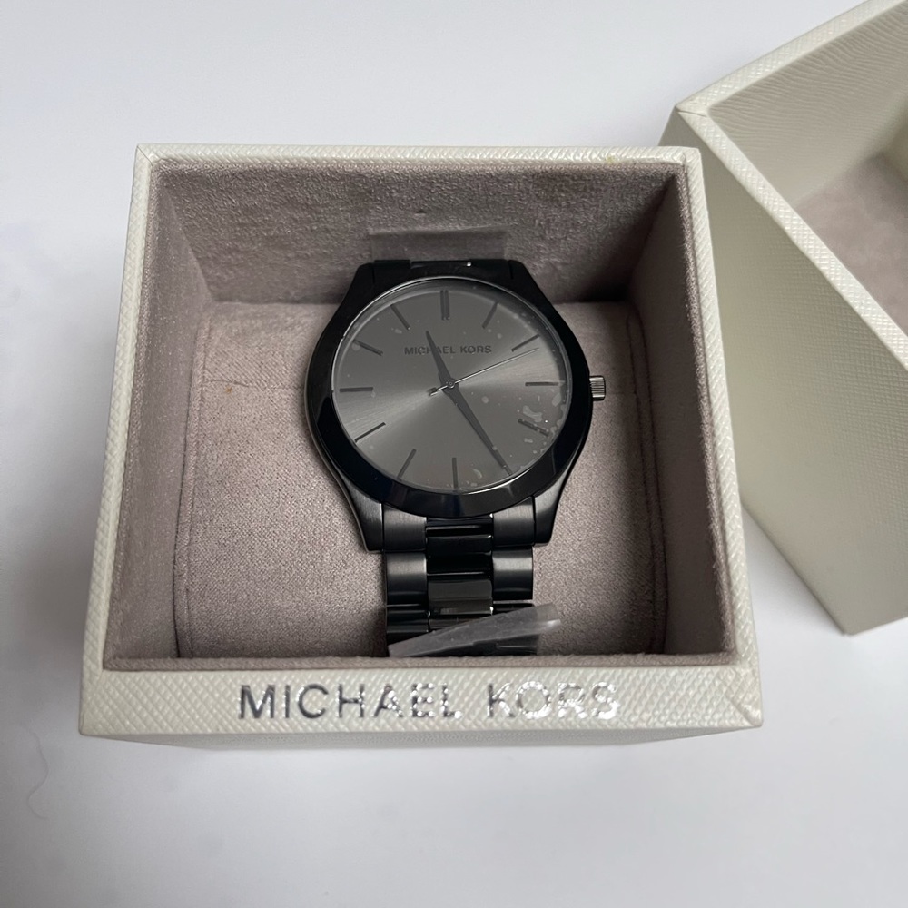 Black oversized women’s Michael Kors watch.